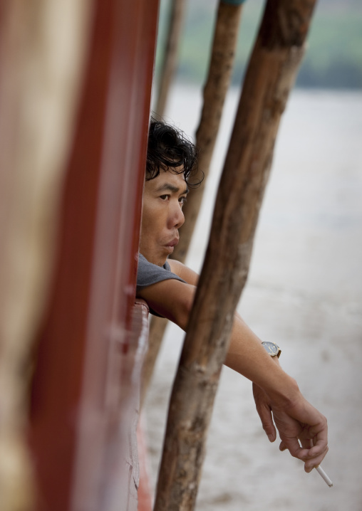 Man on a boat on mekong river, Houei xay, Laos