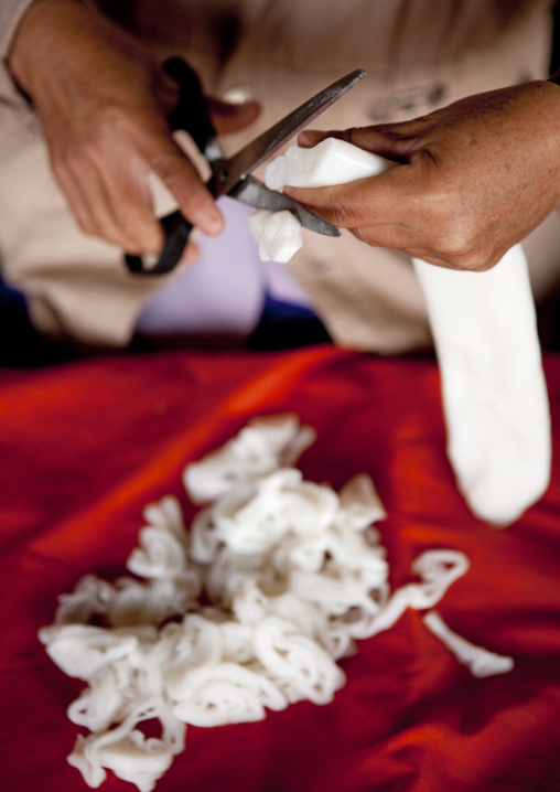 Woman cutting tofu, Muang sing, Laos