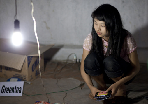 Young woman selling tea at night market, Luang prabang, Laos