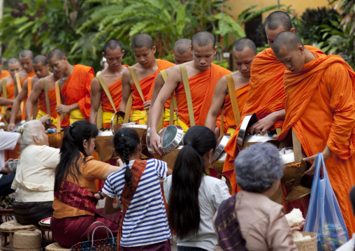 Lao buddhist monks collecting alms, Luang prabang, Laos