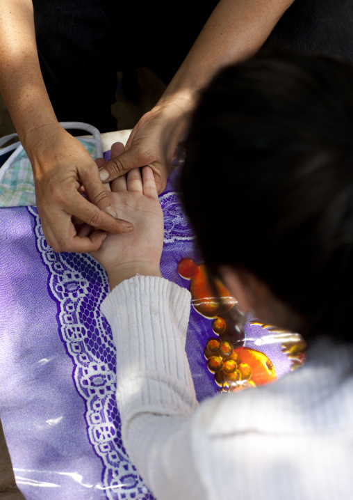 Hand divination in the street, Vientiane, Laos