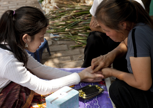 Hand divination in the street, Vientiane, Laos