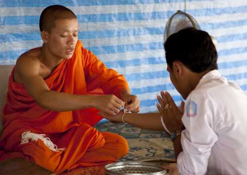 Monk during a baci ceremony in vat si muang, Vientiane, Laos