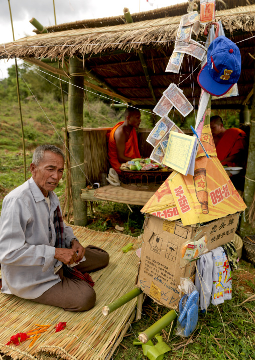 Parent during a death ceremony, Phonsavan, Laos