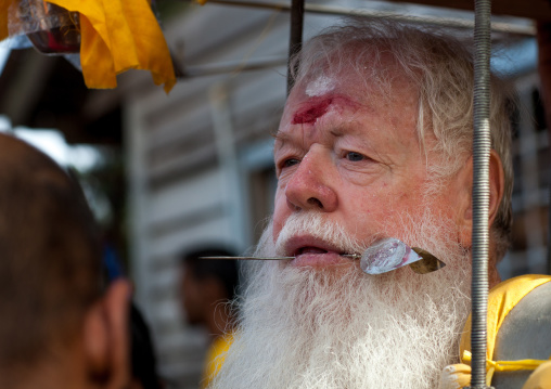 Carl, An Australian Hindu Devotee With A Skewer In The Tongue Carrying A Kavadi In Thaipusam Festival In Batu Caves, Southeast Asia, Kuala Lumpur, Malaysia