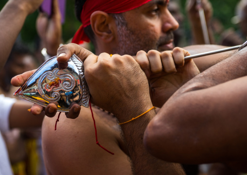 A Devotee Cheek Is Pierced With A Giant Skewer By A Priest At Thaipusam Hindu Festival At Batu Caves, Southeast Asia, Kuala Lumpur, Malaysia