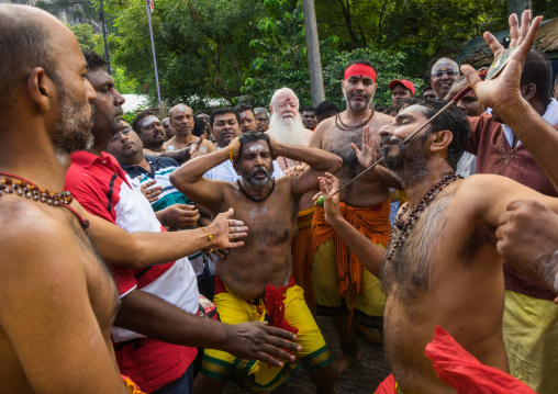 A Devotee Cheek Is Pierced With A Skewer By A Priest At Thaipusam Hindu Festival At Batu Caves, Southeast Asia, Kuala Lumpur, Malaysia