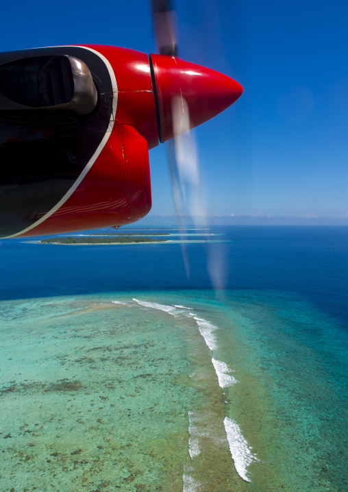 Maldivian Air Taxi Seaplane Flying Over An Atoll, Male, Maldives