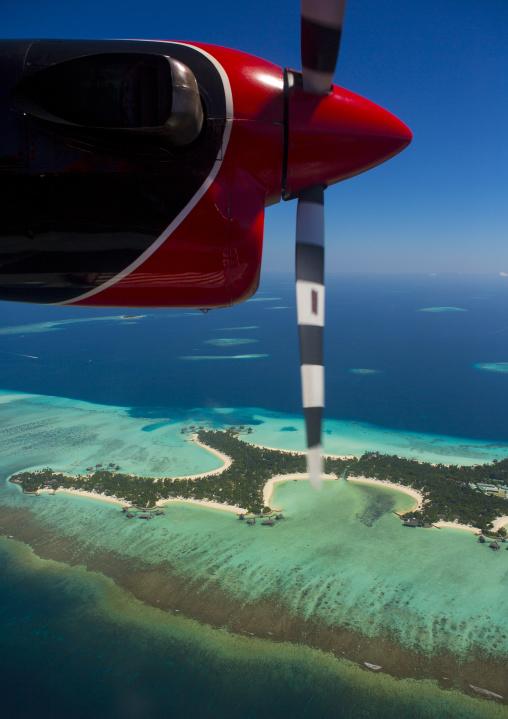 Maldivian Air Taxi Seaplane Flying Over An Atoll, Male, Maldives