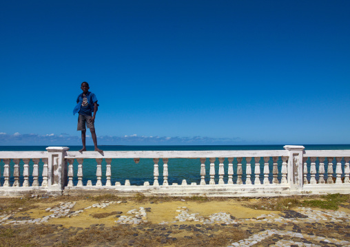 Kid Standing On A Fence, Ilha de Mocambique, Nampula Province, Mozambique