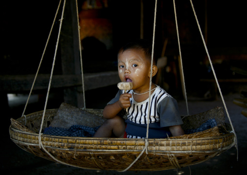 Baby In A Craddle Eating An Ice Cream, Bagan, Myanmar