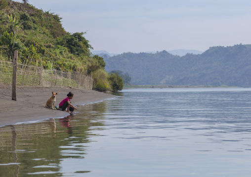 Woman Washing Clothes In Kaladan River, Mrauk U, Myanmar