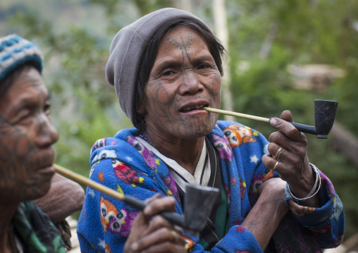 Tribal Chin Women From Muun Tribe With Tattoos On The Face Smoking, Mindat, Myanmar