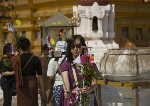 Woman Taking A Picture With A Selfie Stick In A Temple, Bagan, Myanmar