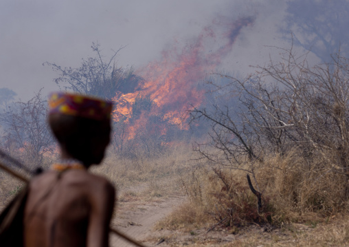 San Man In Front Of A Fire In The Bush, Namibia