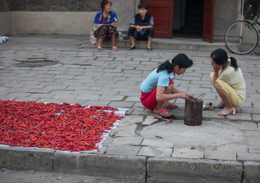 North Korean women sit near dried kimchi, Pyongan Province, Pyongyang, North Korea