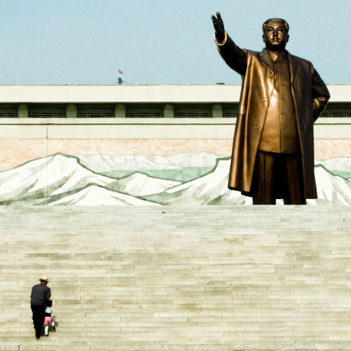 North Korean father and his son climbing the stairs leading to the statue of Kim il Sung in Mansudae Grand monument, Pyongan Province, Pyongyang, North Korea