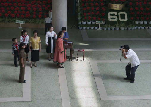 North Korean man taking pictures at the international Kimilsungia and Kimjongilia festival, Pyongan Province, Pyongyang, North Korea