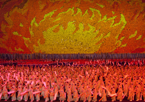 North Korean dancers in front of a sky of fire made by children pixels holding up colored boards during Arirang mass games in may day stadium, Pyongan Province, Pyongyang, North Korea