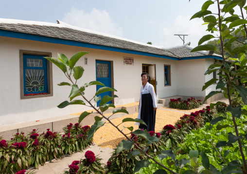 North Korean guide in front of a model house that was visited by the Dear Leaders, North Hwanghae Province, Sariwon, North Korea