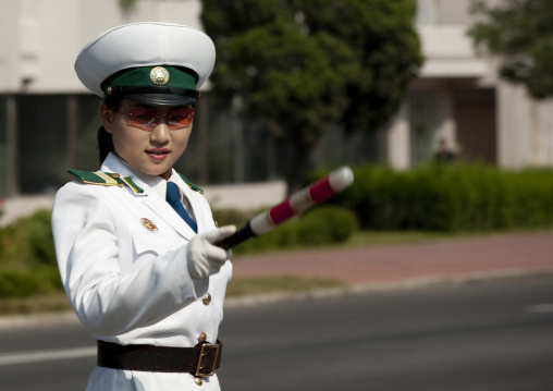 North Korean female traffic security officer in white uniform in the street, Pyongan Province, Pyongyang, North Korea