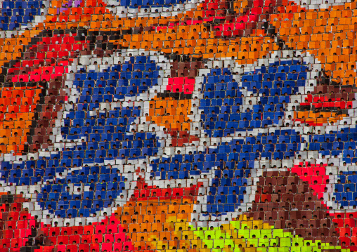 Korean letters made by children pixels holding up colored boards during Arirang mass games in may day stadium, Pyongan Province, Pyongyang, North Korea