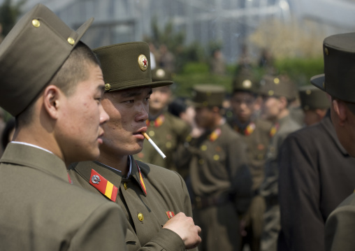 North Korean soldeirs smoking cigarettes in the street, Pyongan Province, Pyongyang, North Korea