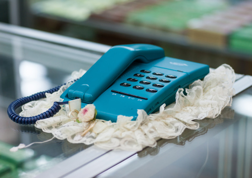 An old blue fashioned telephone on a dresser in Yanggakdo international hotel, Pyongan Province, Pyongyang, North Korea