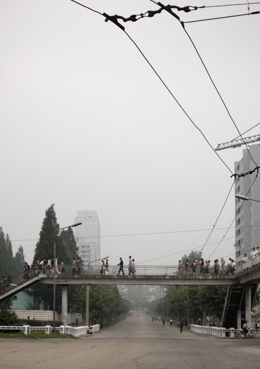 North Korean people crossing a bridge in town, Pyongan Province, Pyongyang, North Korea