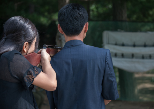 North Korean woman shooting on an target with an american soldier, Pyongan Province, Pyongyang, North Korea