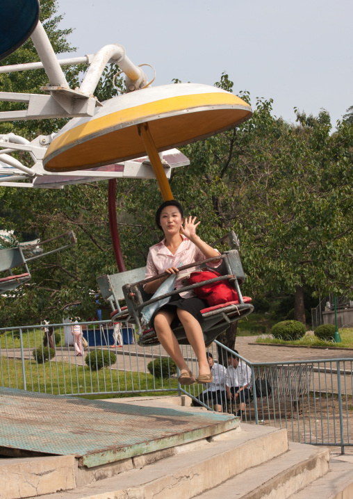 North Korean woman on an attraction in Taesongsan funfair, Pyongan Province, Pyongyang, North Korea