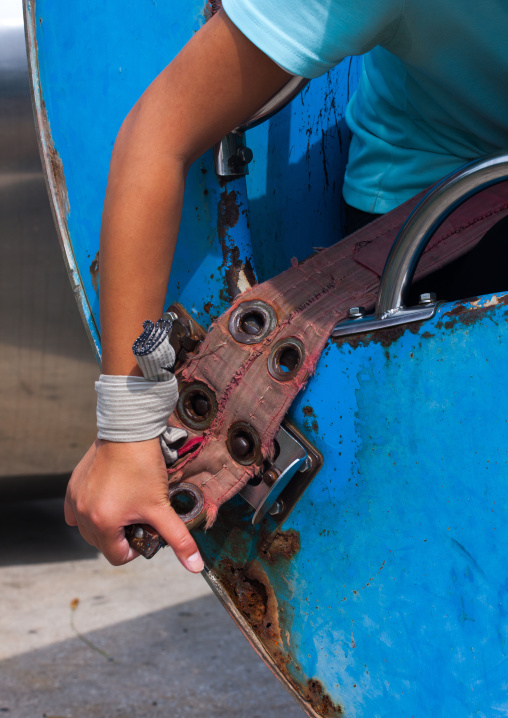 North Korean girl attaching her belt in an attraction in Taesongsan funfair, Pyongan Province, Pyongyang, North Korea