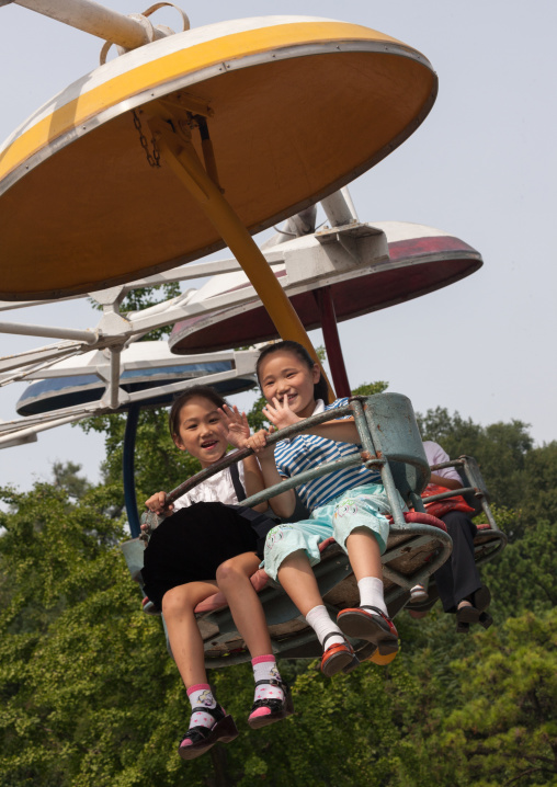 North Korean children on an attraction in Taesongsan funfair, Pyongan Province, Pyongyang, North Korea