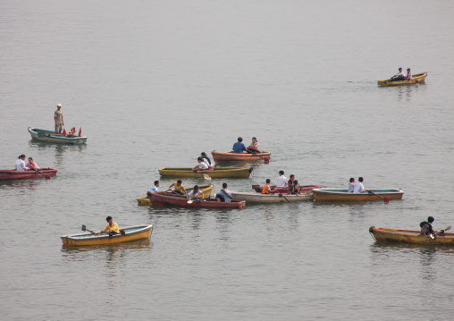 North Korean people paddling on small boats on Taedong river, Pyongan Province, Pyongyang, North Korea