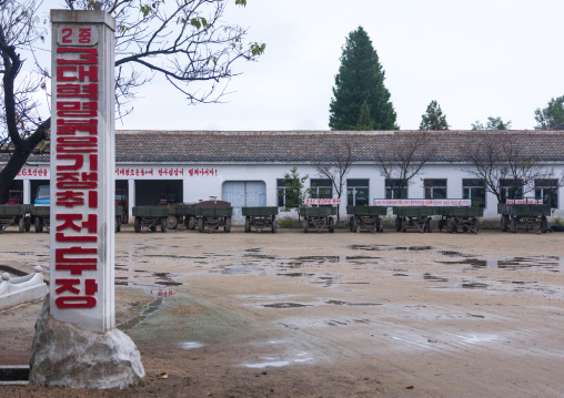 Trucks parked in a farm courtyard, South Hamgyong Province, Hamhung, North Korea