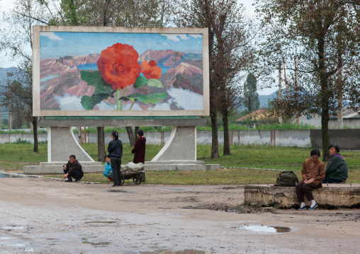 North Korean propaganda billboard depicting a Kimilsungia flower on mount Paektu, North Hamgyong Province, Jung Pyong Ri, North Korea