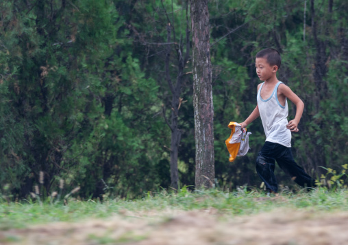 North Korean skinny boy in a park, Pyongan Province, Pyongyang, North Korea