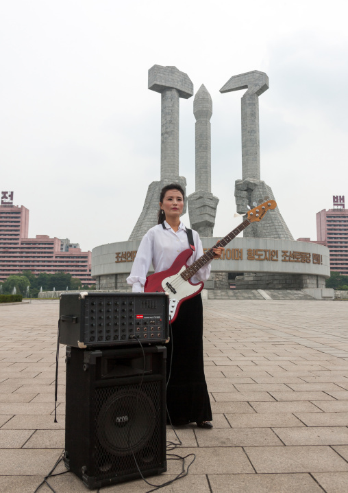 North Korean state artist performing on national day in front of the monument to Party founding, Pyongan Province, Pyongyang, North Korea