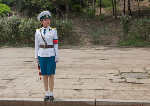 North Korean female traffic security officer in white uniform in the street, Pyongan Province, Pyongyang, North Korea