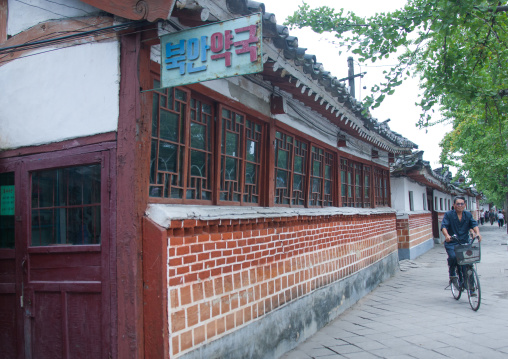 North Korean man on a bicycle in the old town, North Hwanghae Province, Kaesong, North Korea