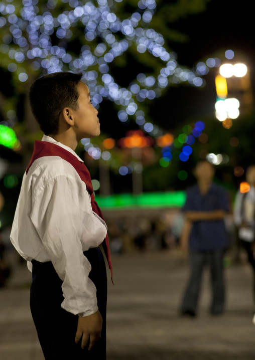 North Korean young pioneer boy staring at Kaeson youth park fun fair, Pyongan Province, Pyongyang, North Korea