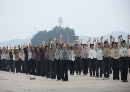 Women raising hands during morning exercise session, Kangwon Province, Wonsan, North Korea