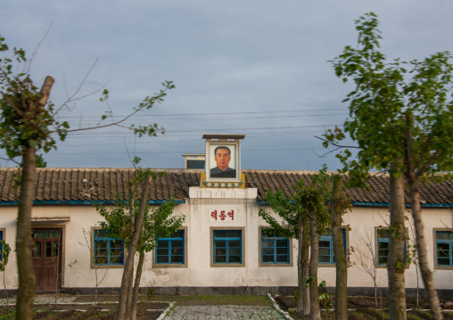 Kim il Sung portrait at the top of an official building, South Pyongan Province, Nampo, North Korea