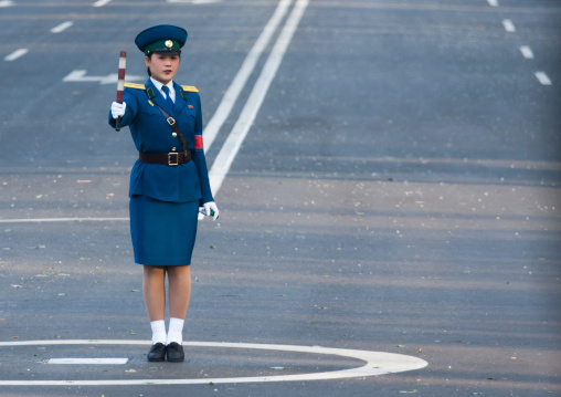 North Korean traffic security officer in blue uniform in the street, Pyongan Province, Pyongyang, North Korea