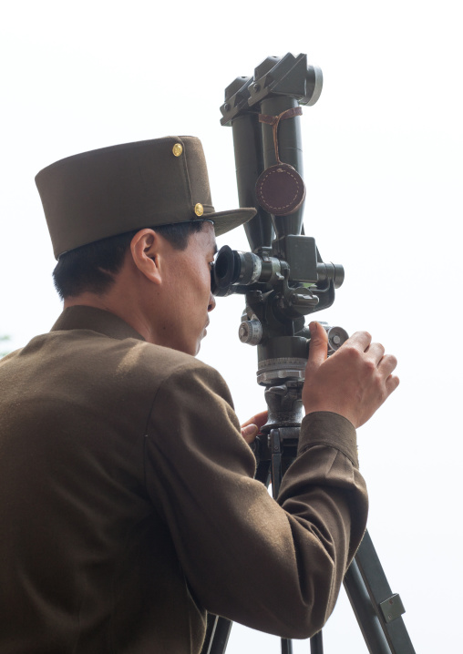 North Korean soldier looking south Korea with binoculars at the Demilitarized Zone, North Hwanghae Province, Panmunjom, North Korea