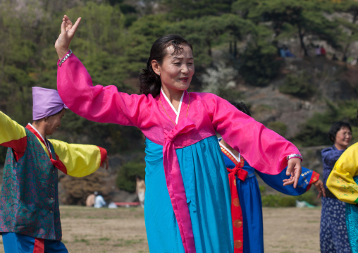 North Korean people dancing in a park for the day of the sun which is the birth anniversary of Kim Il-sung, Pyongan Province, Pyongyang, North Korea