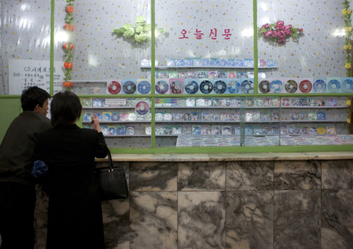 North Korean peiople in front of a dvd and gifts shop inside the subway, Pyongan Province, Pyongyang, North Korea