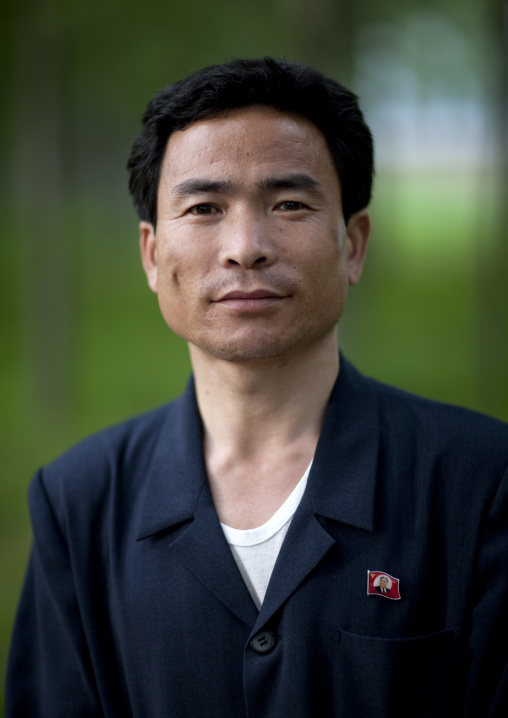 North Korean man with a workers' Party of North Korea with Kim il Sung pin, South Pyongan Province, Nampo, North Korea