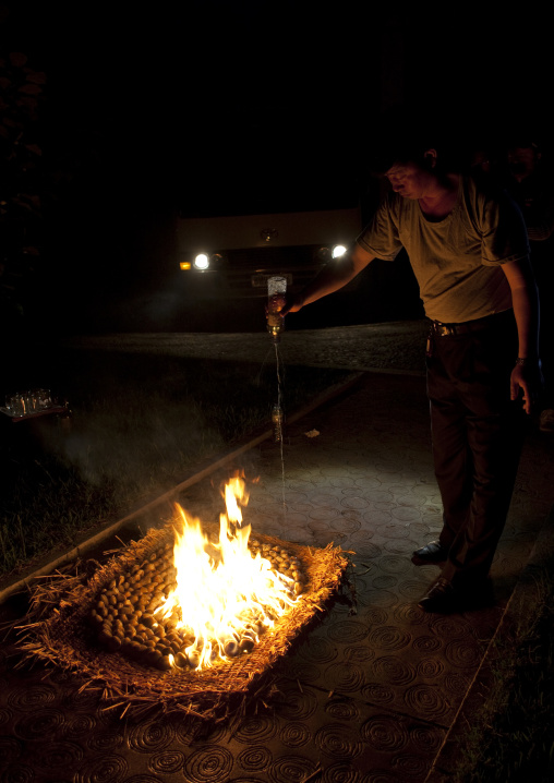 North Korean man cooking clams with petrol, South Pyongan Province, Nampo, North Korea