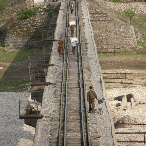 North Korean people walking on an empty railway, Pyongan Province, Myohyang-san, North Korea